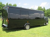 black 25 passenger executive bus, dr